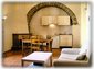 Open Living/Dining Area with vaulted ceiling, fireplace and origional stone-work