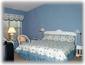 Master bedroom with king bed/master bath and windows looking over pool 