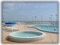 Upper level of the sun deck overlooking the tennis court and the beach