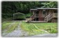 Front Of Cabin With Carport & Driveway