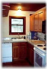 Kitchen is a joy to work in, window allows view of sunroom & back yard BBQ.