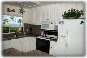Spacious gourmet kitchen with same western view of the lanai