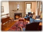The living room with fireplace & river views is furnished in 18th-century style.