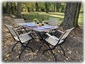 Enjoy alfresco dining at the teak table and chairs under the backyard maple.