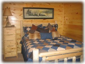 Game Room level Cowboy room with log queen pillow top bed
