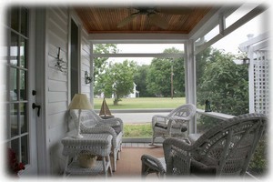 e Screened-In Porch w/ ceiling fan overlooking gardens