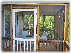 Screened enclosed patio with table and chairs