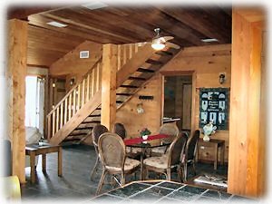 A shot of the dining area with the floating black walnut stairs to the loft