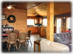 A view of the dining area with the kitchen in the background