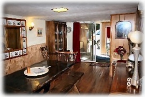 Butcher block dining table in the center of this huge dining room