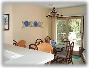 Looking from the end of the hallway toward the dining area and the deck door 