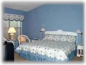 Master bedroom with king bed/master bath and windows looking over pool