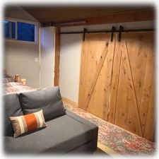 Barn doors in kids loft close it off to downstairs