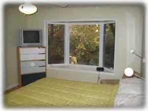 Bedroom with bay window overlooking river