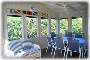 screen porch with room for eating and relaxing