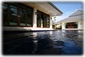 The living room and master bedroom across the pool