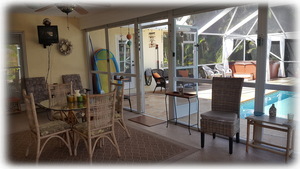 Screened Florida Room Overlooking Pool Deck with Various Sitting Areas