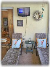 Screened Florida Room with Television & Padded Lounge Chairs
