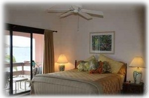 King Size Bed with Patio looking out over the ocean.