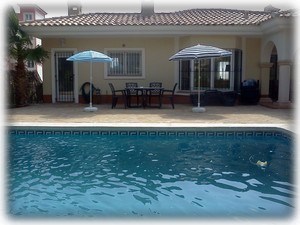 Pool with umbrellas & garden diningtable