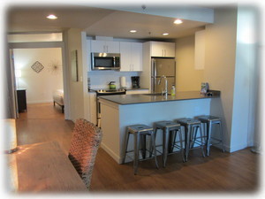 Writing desk and kitchen (2nd bedroom in background)