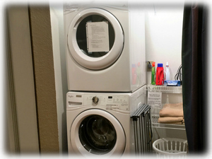 A washer & dryer are in the condo