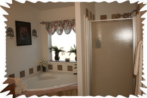 Master Bathroom with large tub and walk-in glass shower.