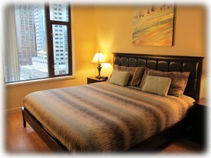 Master bedroom with king bed and city views