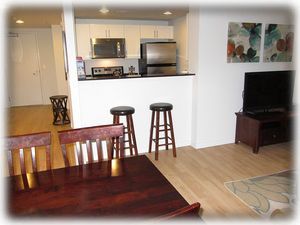 Dining area with kitchen beyond and entry (left on photo)