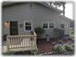 Front Of Chalet Showing Garden, Side Entrance On Right, & Carport