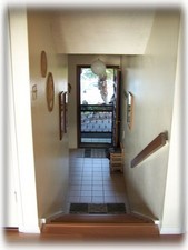 Stairs that separate bedroom/bathroom area from living/dining room & kitchen.