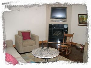 TV Room with fireplace faces the water.