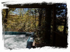 Hot tub right out the back door overlooks a wooded wonderland and mountain view.