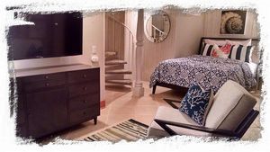 Lower level bedroom suite has queen bed, sitting area and private bathroom.