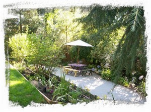 Lawn, flower beds, picnic table/benches, granite pathway.