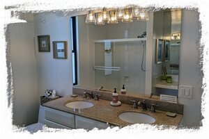 Primary bathroom features dual vanities