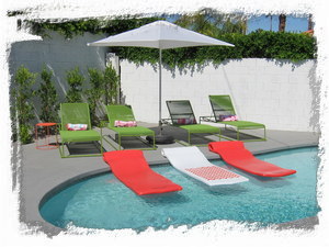 Pool area has large deck with several lounges and pool floats