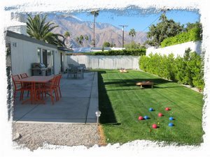 Large backyard lawn for games with provided corn hole set, bocce balls & croquet