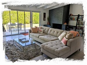 True indoor/outdoor living with our wall of windows and original brick fireplace