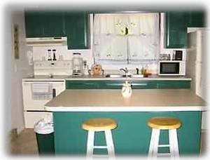 Adorable kitchen with brand new appliances and cooking utensils.