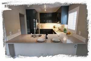 Modern kitchen with glossy cabinets & quartz counters