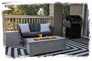 Balcony features fire table sitting area and gas grill