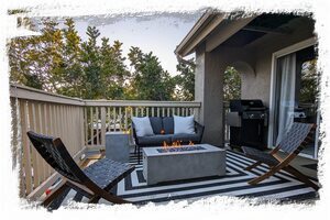 Balcony features fire table sitting area and gas grill