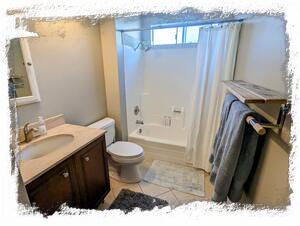 Second bathroom features shower over tub