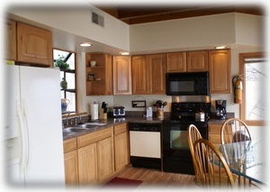 New Hickory cabinets, wood flooring, counter tops, range oven & more!