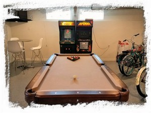 Hang out in our game room with pool table, arcade classics, bistro set and TV